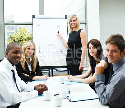 Attractive businesswoman giving a presentation smiling at the ca