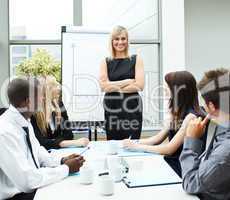 Attractive businesswoman in a meeting with folded arms