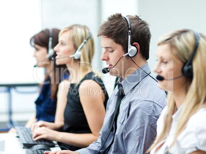 Attractive young man working in a call center