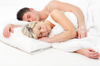 Blonde girl sleeping with a boy in bed
