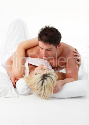 Boyfriend hugging his girlfriend in bed