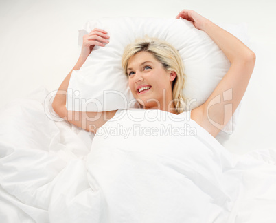 Happy girl lying in bed