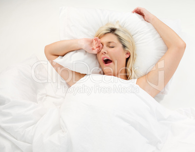 Girl yawning in bed after sleeping