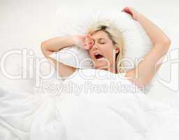 Girl yawning in bed after sleeping