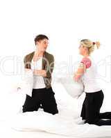 Boy and girl having a pillow fight