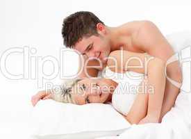 Happy young couple in bed