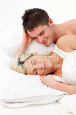 Boy looking at her girlfriend sleeping