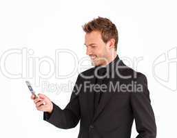 Smiling businessman writing a message with a mobile phone