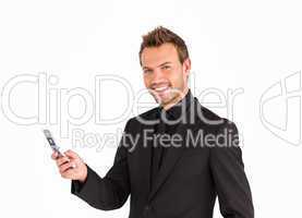 Young businessman texting and smiling at the camera