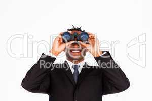 Handsome businessman holding binoculars upwards