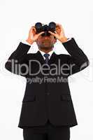 Serious afro-american businessman using bioculars