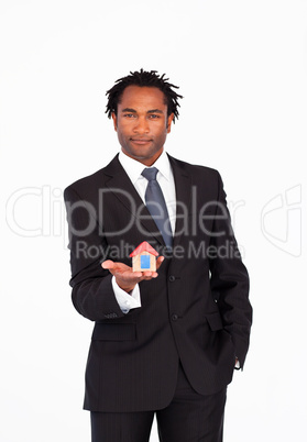 Friendly businessman holding a house