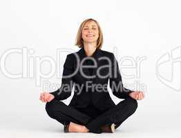 Smiling businesswoman doing yoga exercises