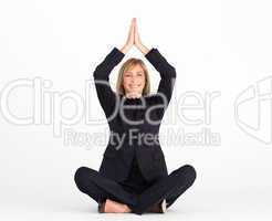 Businesswoman resting on floor doing yoga