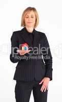 Confident businesswoman holding a house