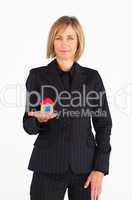 Mature businesswoman holding a house