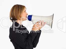 Profile of a businesswoman shouting through a megaphone