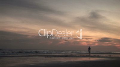 (1046) Man Riding Bicycle on Beach at Sunrise Summer
