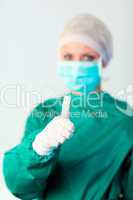 Female surgeon with Thumb in focus