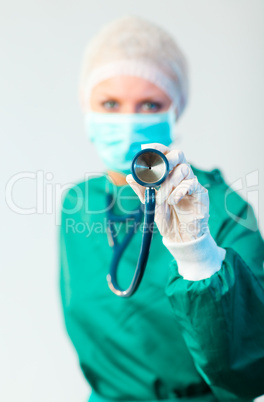 Female Suregon holding stethoscope outwards with focus on the st