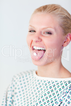 Patient with a pill in her mouth