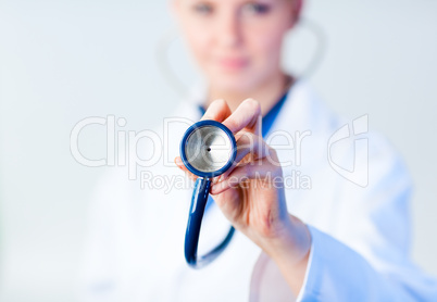 Doctor holding out stethescope with focus on object