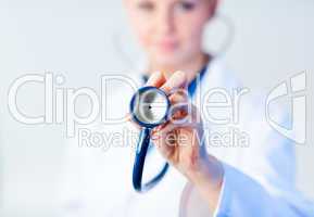 Doctor holding out stethescope with focus on object