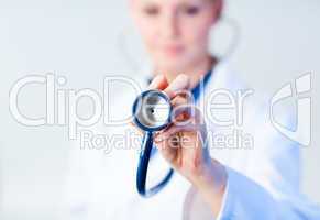 Doctor holding out stethescope with focus on object