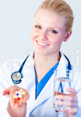 Doctor holding pills to camera