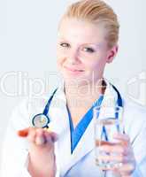 Doctor holding pills to camera