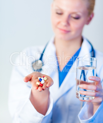 Doctor holding pills to camera