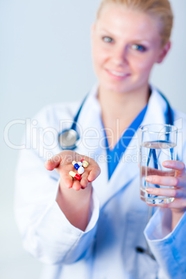 Doctor holding pills out