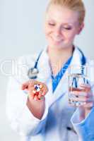 Doctor holding pills out
