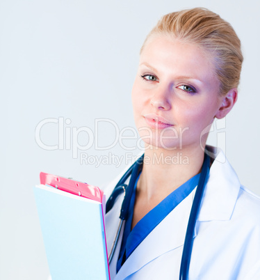 Serious doctor holding a clipboard