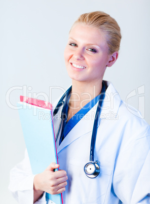 female doctor holding clip board and smiling