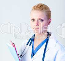 Serious doctor holding a clipboard