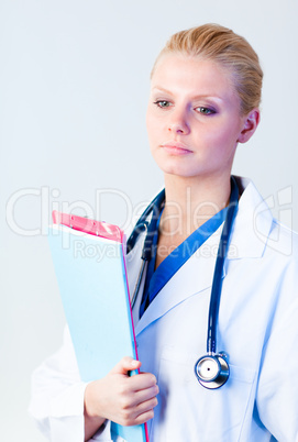 Serious doctor holding a clipboard