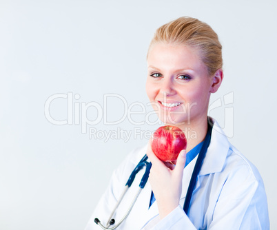 Doctor holding an apple with focus on person
