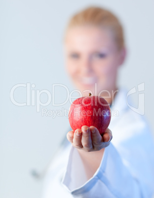 Doctor holding an apple with focus on the apple