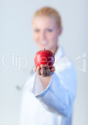 Doctor holding an apple with focus on the apple