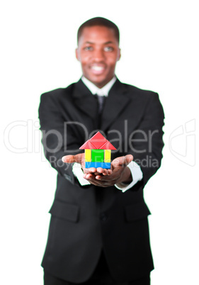 Happy businessman presenting a house