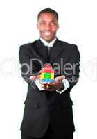 Happy businessman presenting a house