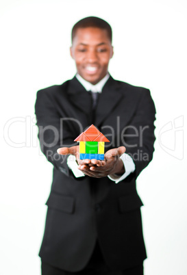 Friendly businessman holding a house in his hands