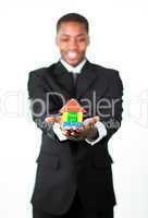 Friendly businessman holding a house in his hands