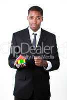 Confident businessman with a house for an real estate concept
