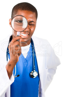 Handsome doctor looking through a magnifying glass