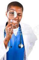 Handsome doctor looking through a magnifying glass
