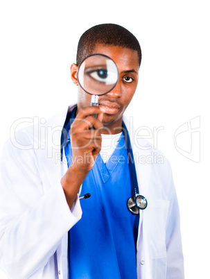 Confident doctor looking through a magnifying glass