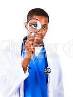 Confident doctor looking through a magnifying glass