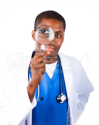 Thoughtful doctor looking through a magnifying glass
